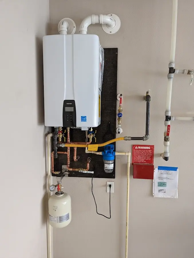 Professional plumber installing copper piping in a DeBary home